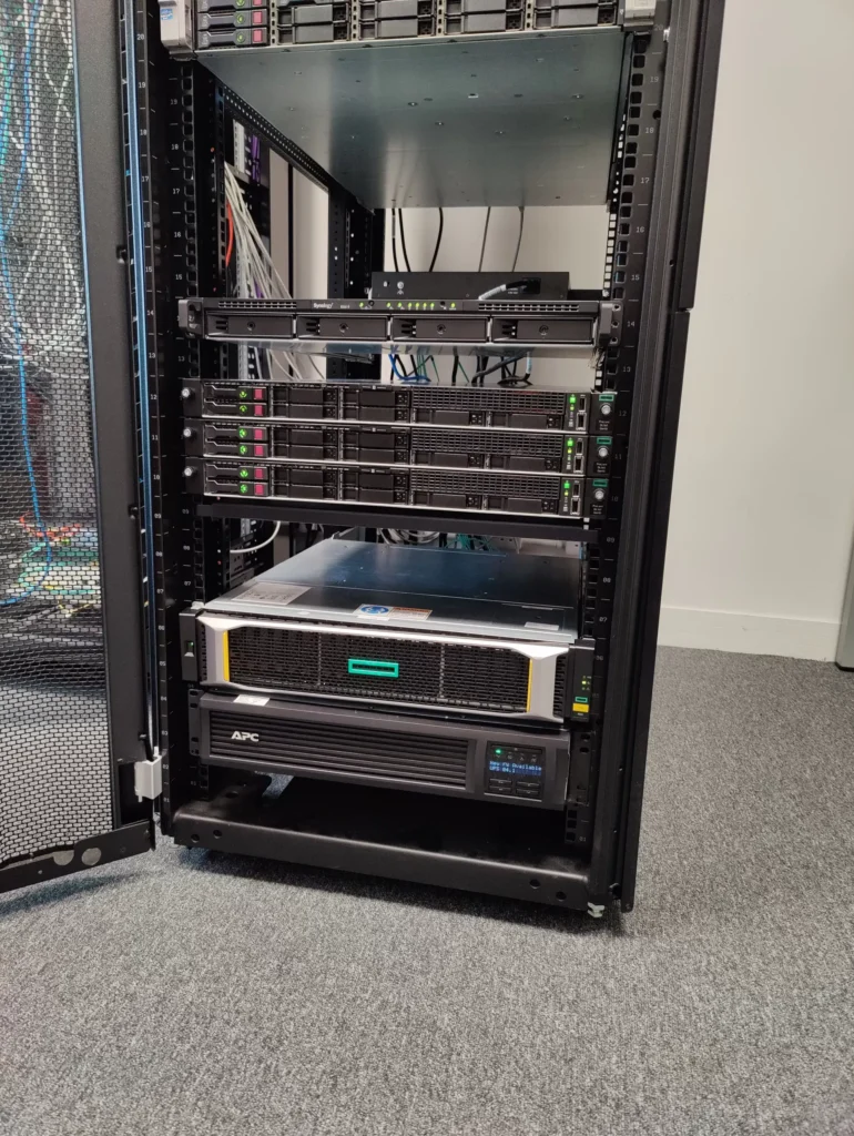 Server rack with networking equipment at Smart IT office.