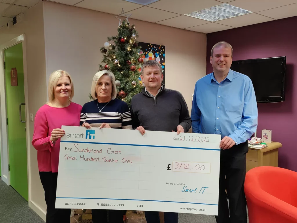 Smart IT team presents charity cheque for £312 at Christmas event.
