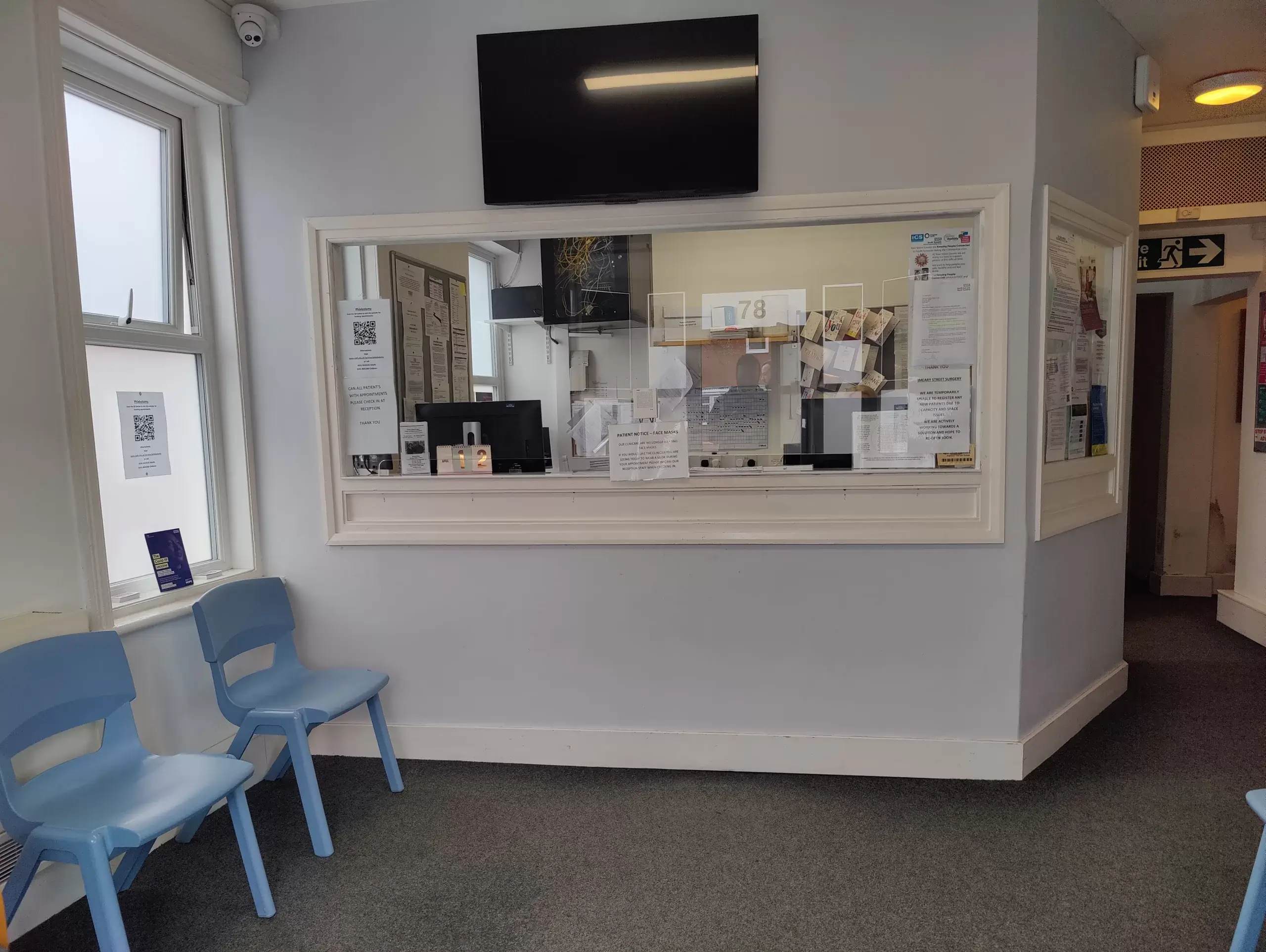 Reception area at Imeary Street Surgery with chairs and notice board.