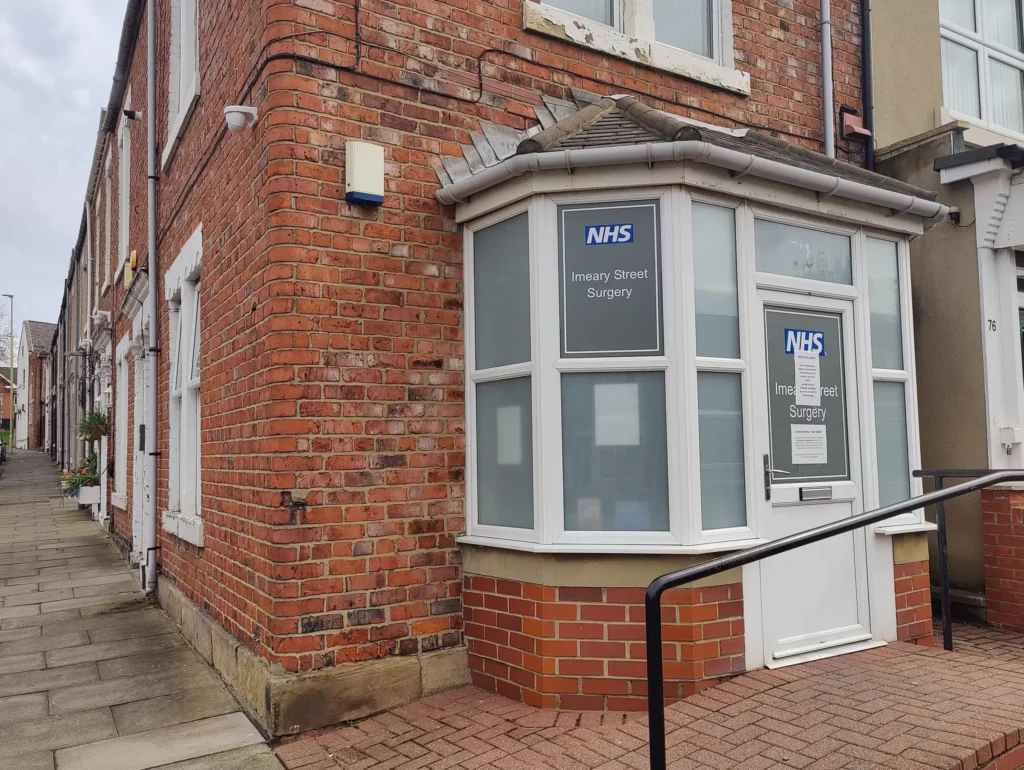 Exterior of Imeary Street Surgery with NHS signage and bay window.