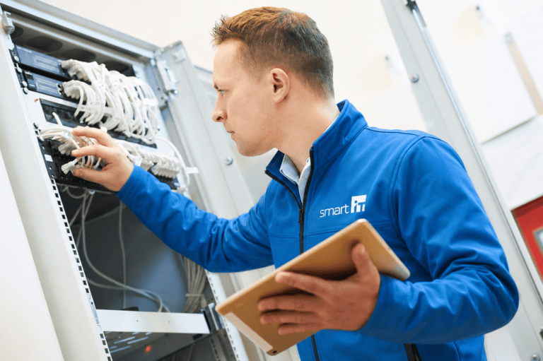 IT technician configuring network server in data centre.